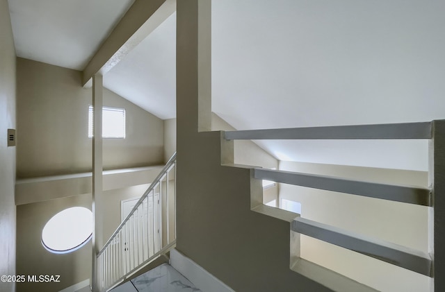 bathroom featuring lofted ceiling with beams, baseboards, and marble finish floor