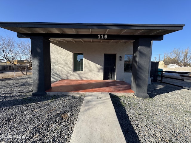 exterior space with fence and stucco siding