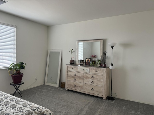 bedroom featuring dark carpet