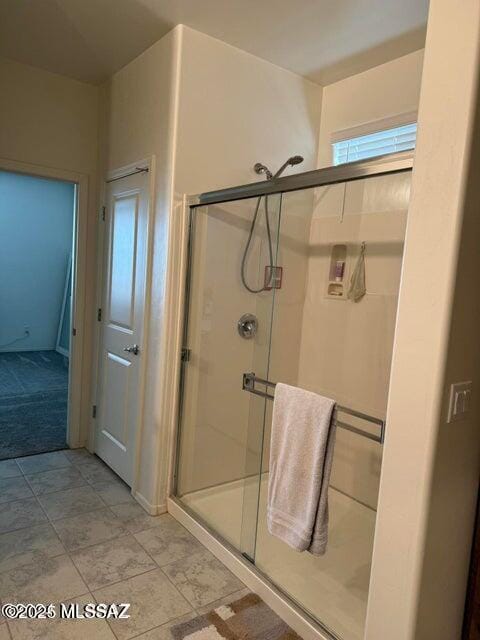 bathroom with a shower with shower door