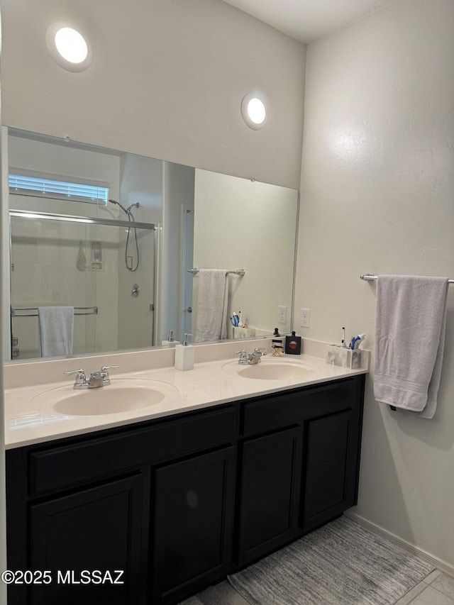 bathroom featuring walk in shower and vanity