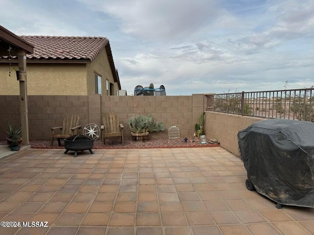 view of patio / terrace featuring a grill and an outdoor fire pit