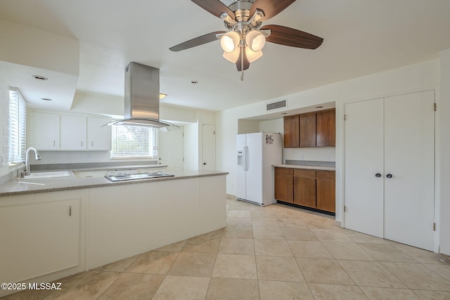 kitchen with white appliances, a sink, visible vents, light countertops, and island exhaust hood