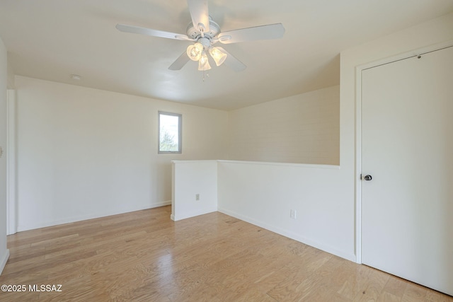 spare room featuring ceiling fan and light wood-type flooring