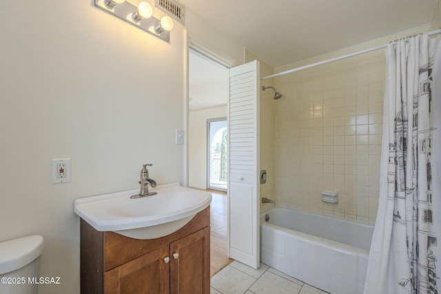 bathroom with tile patterned flooring, toilet, vanity, visible vents, and shower / bathtub combination with curtain