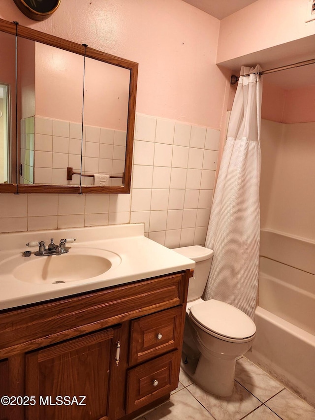 full bathroom featuring tile walls, vanity, toilet, shower / bath combo, and tile patterned floors