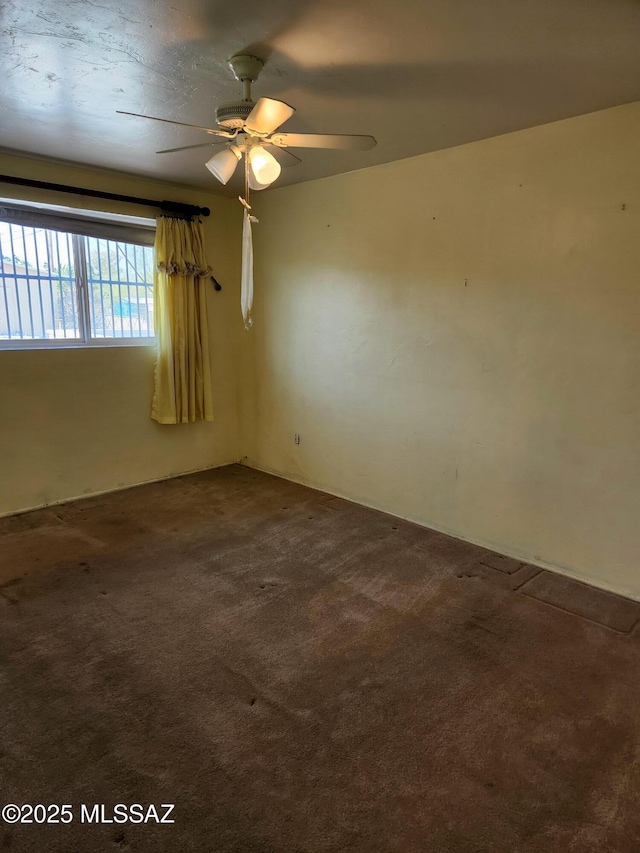 carpeted empty room with ceiling fan