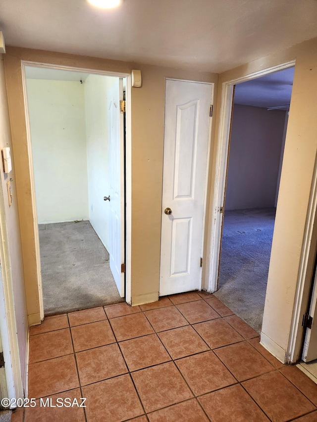 hallway featuring light carpet