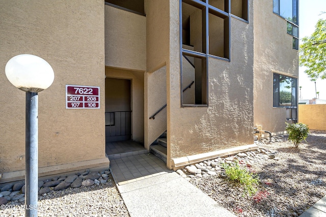 property entrance featuring stucco siding