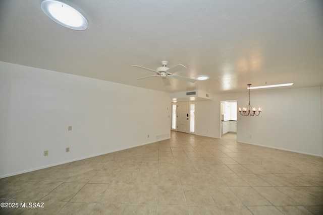 empty room featuring ceiling fan with notable chandelier