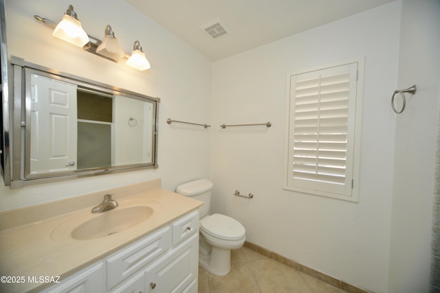 bathroom featuring vanity, tile patterned floors, and toilet