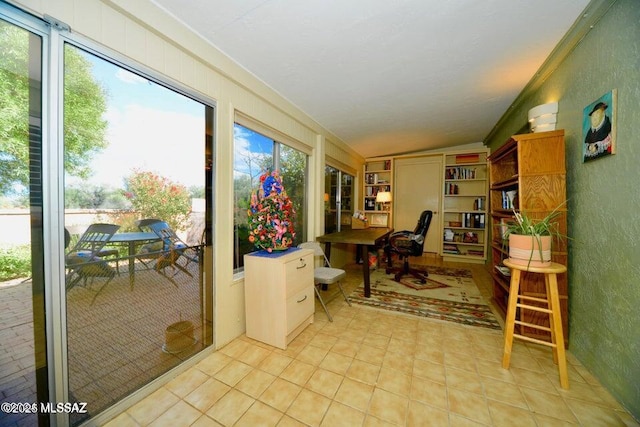 interior space with vaulted ceiling and light tile patterned flooring