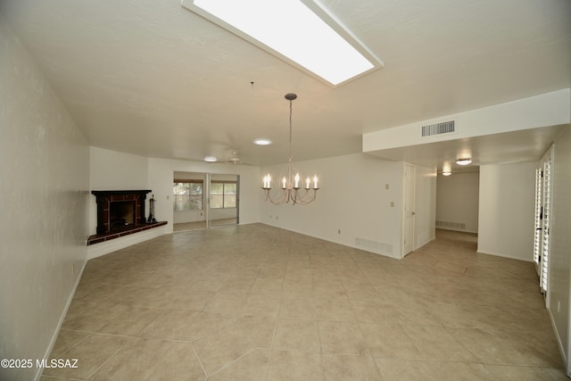 unfurnished living room with an inviting chandelier