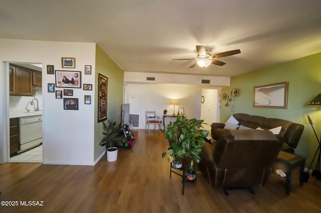 living room featuring sink, light hardwood / wood-style floors, and ceiling fan