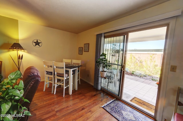 dining space with wood-type flooring