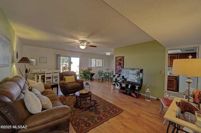 living room with ceiling fan and light wood-type flooring