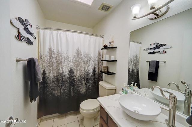 bathroom with tile patterned flooring, vanity, curtained shower, and toilet