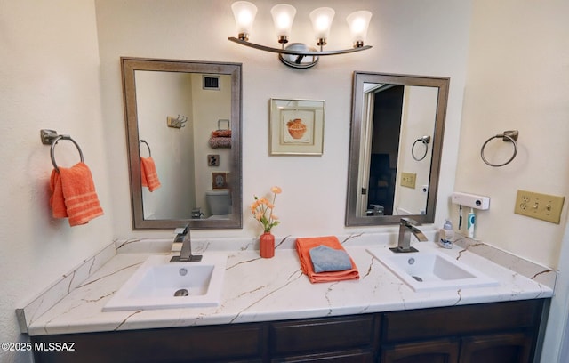 bathroom featuring vanity and toilet