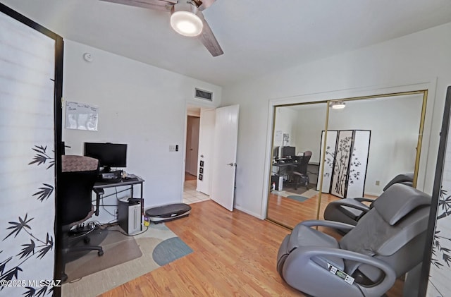 office with ceiling fan and light hardwood / wood-style floors