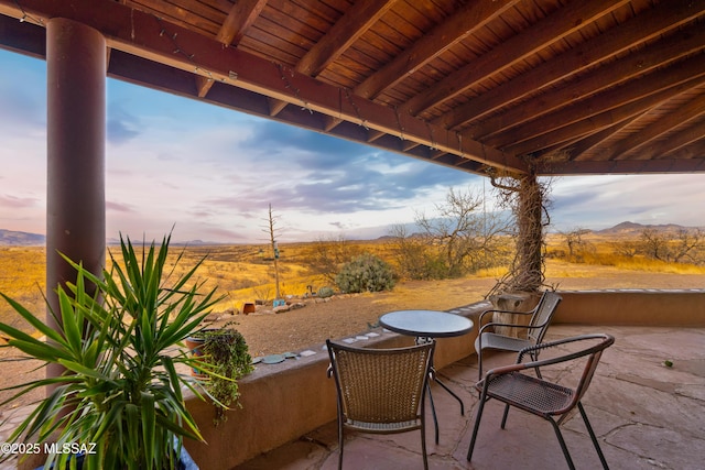 patio terrace at dusk with a mountain view