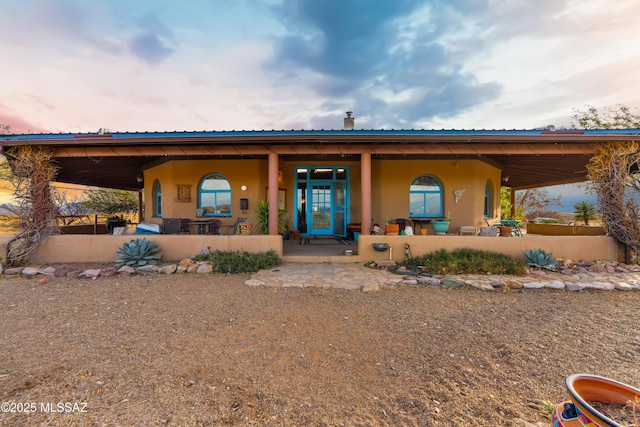 view of front of home with a porch and stucco siding