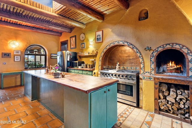 kitchen with wooden ceiling, butcher block counters, beamed ceiling, stainless steel appliances, and green cabinetry