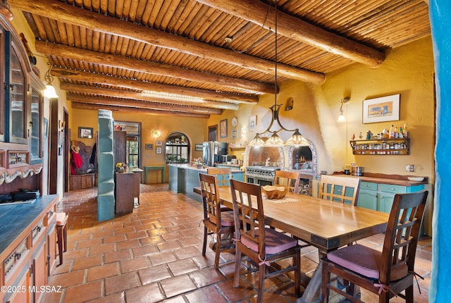 dining room with brick floor, wood ceiling, and beam ceiling