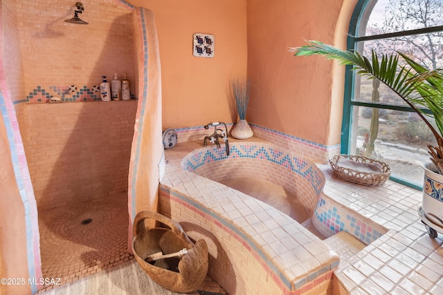 bathroom with tile patterned flooring and tiled shower