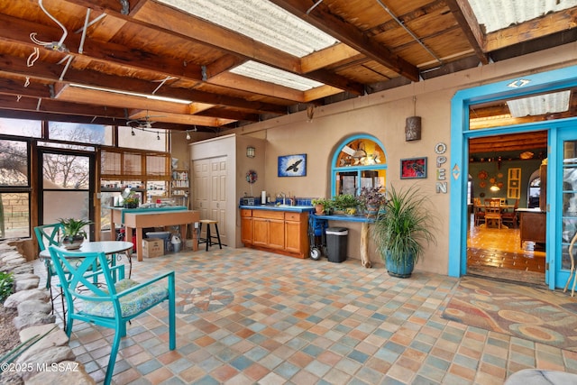 interior space featuring wood ceiling, a sink, and beam ceiling