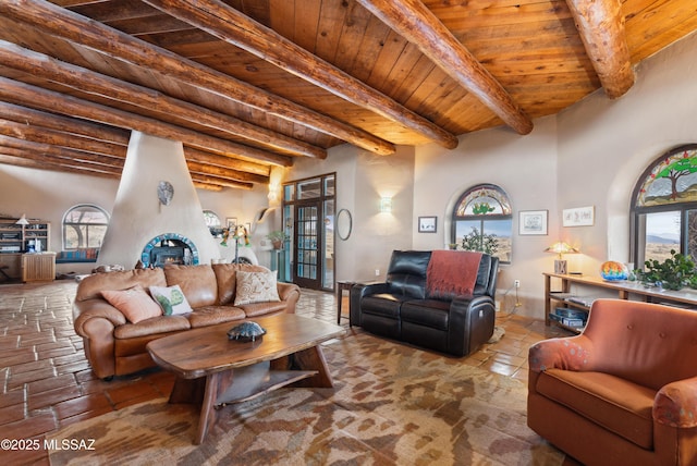 living room featuring a large fireplace, wood ceiling, and beam ceiling