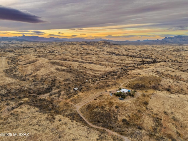 aerial view at dusk featuring a mountain view