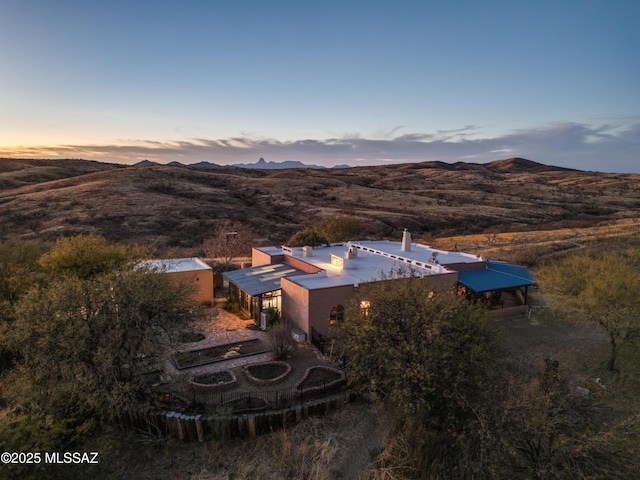 aerial view at dusk featuring a mountain view