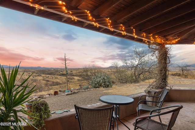 patio terrace at dusk with a mountain view