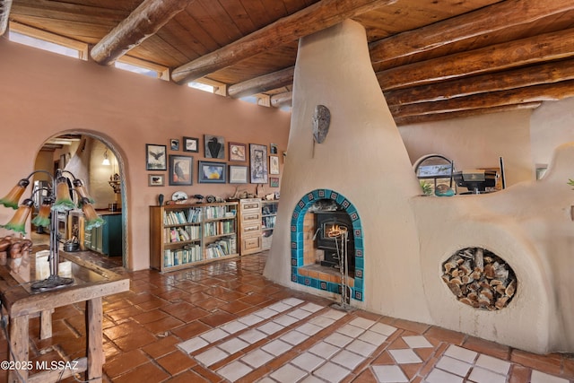 corridor with wooden ceiling, arched walkways, and beam ceiling