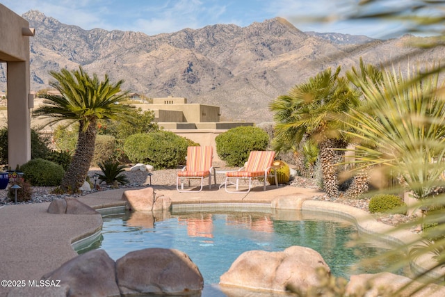 view of swimming pool with a patio, a mountain view, and a fenced in pool