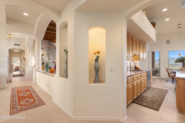 corridor featuring recessed lighting, visible vents, a sink, and light tile patterned floors