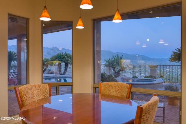 dining room featuring a mountain view and a healthy amount of sunlight