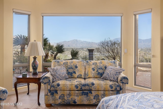 bedroom featuring multiple windows, light tile patterned flooring, and a mountain view