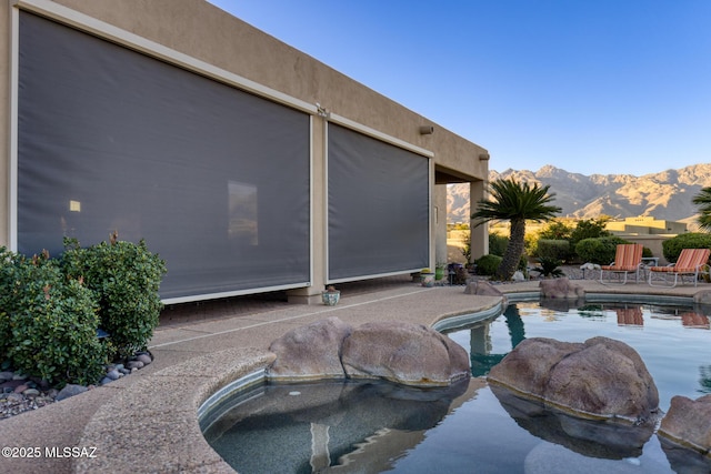 view of pool with a patio area, a mountain view, and a fenced in pool