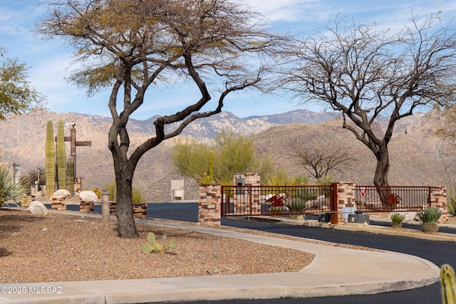 exterior space with a gate and a mountain view