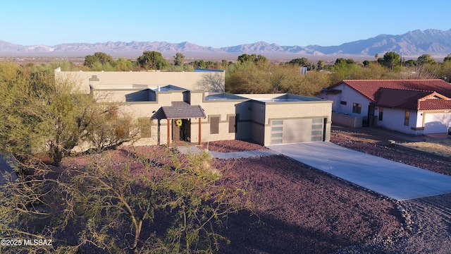 view of front of property with a garage and a mountain view