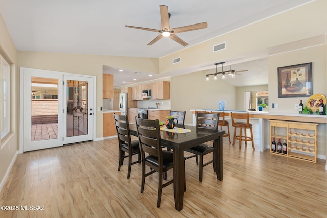 dining area with lofted ceiling, light hardwood / wood-style flooring, and ceiling fan