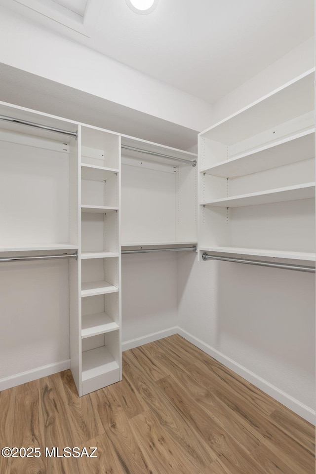 walk in closet featuring wood finished floors