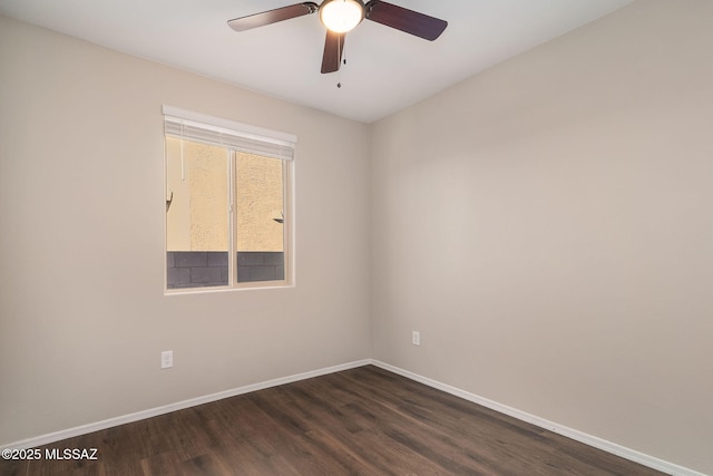 unfurnished room featuring a ceiling fan, baseboards, and dark wood-type flooring