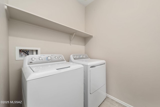 laundry area featuring laundry area, washer and clothes dryer, and baseboards