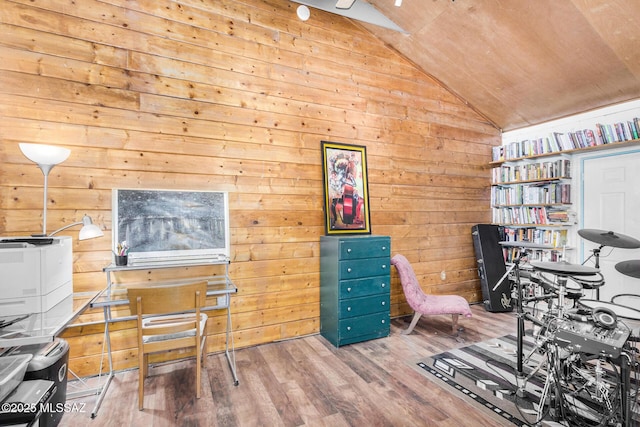 office space with hardwood / wood-style floors, vaulted ceiling, and wood walls