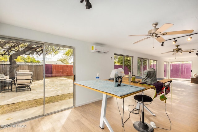 dining space with light hardwood / wood-style flooring and an AC wall unit