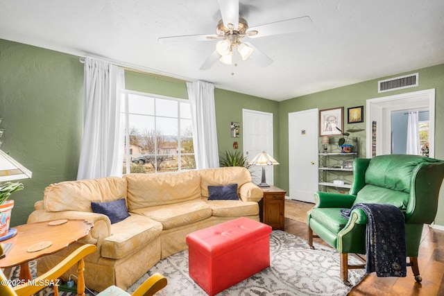 living room with ceiling fan and a wealth of natural light