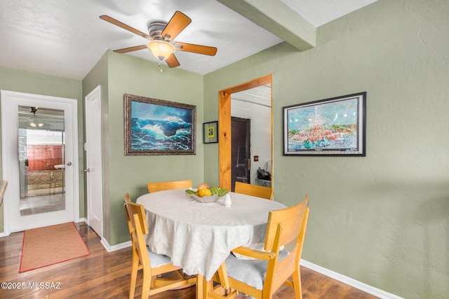 dining room with beamed ceiling, dark wood-type flooring, and ceiling fan