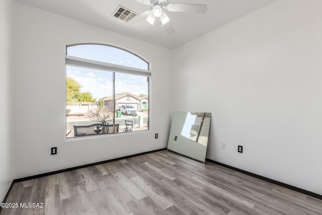 unfurnished room with ceiling fan and light wood-type flooring